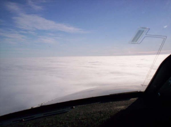 Over an overcast layer above Saskatchewan. Pilot: Dave Woollam.